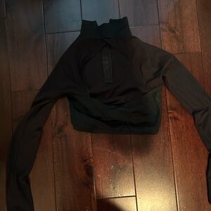 Cropped black top with sheer sleeves and back cut out with hip hop pants.